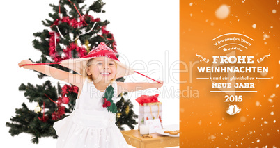 Composite image of festive little girl smiling at camera