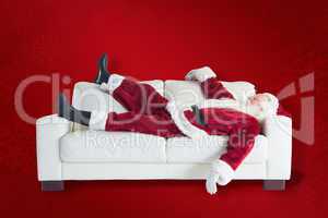 Composite image of santa claus taking a nap