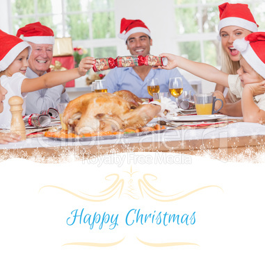 Composite image of siblings pulling a christmas cracker