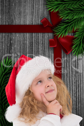 Composite image of festive little girl thinking and looking up