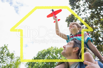 Composite image of boy with toy aeroplane sitting on fathers sho