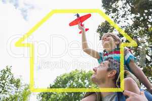 Composite image of boy with toy aeroplane sitting on fathers sho