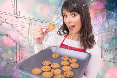 Composite image of festive brunette showing hot cookies