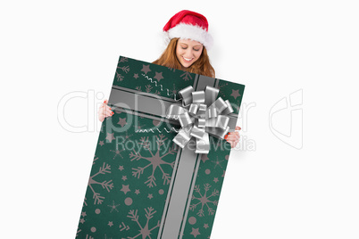 Composite image of festive redhead smiling at camera holding pos