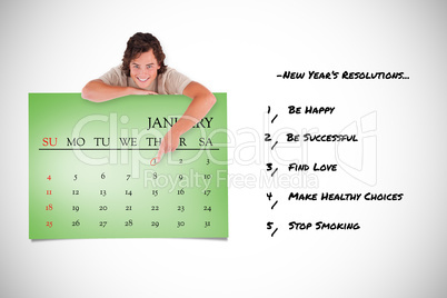 Composite image of smiling man pointing at a calendar
