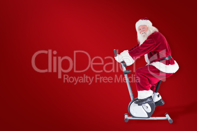 Composite image of santa uses a home trainer