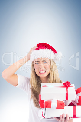 Festive blonde holding pile of gifts