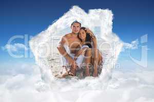 Composite image of cuddling couple smiling at camera