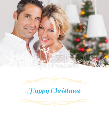 Composite image of couple embracing at christmas