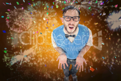 Composite image of geeky hipster looking confused at camera