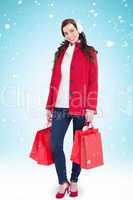 Composite image of happy brunette in winter clothes holding shop