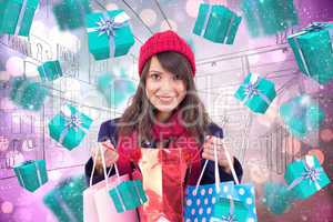 Composite image of smiling brunette opening gift bag