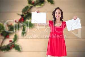 Composite image of stylish brunette in red dress holding pages