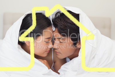 Composite image of happy couple lying on bed together under the