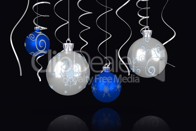 Composite image of blue and silver christmas baubles