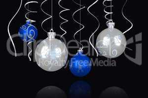 Composite image of blue and silver christmas baubles