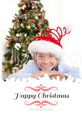 Composite image of portrait of a smiling boy wearing a christmas