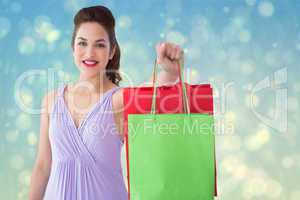 Composite image of portrait of pretty brunette showing shopping