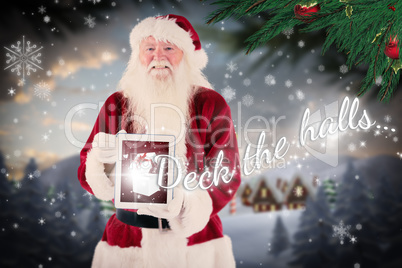 Composite image of santa presents a tablet pc