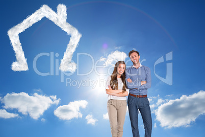 Composite image of smiling young couple with arms crossed