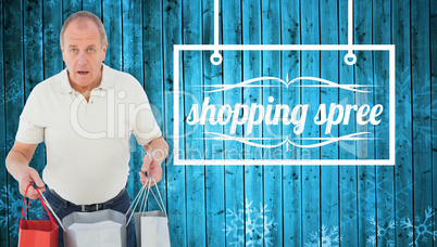 Composite image of shocked man holding shopping bags