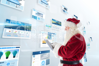 Composite image of santa uses a tablet pc