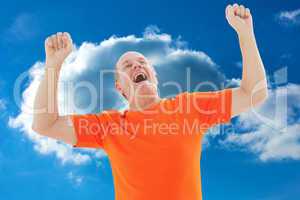 Composite image of mature man in orange tshirt cheering