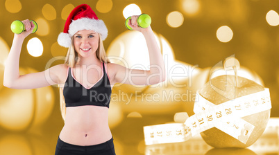 Composite image of festive fit blonde smiling at camera