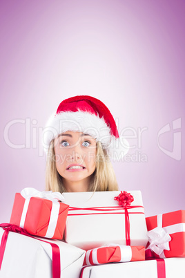 Festive blonde holding pile of gifts