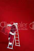 Composite image of santa steps up a ladder