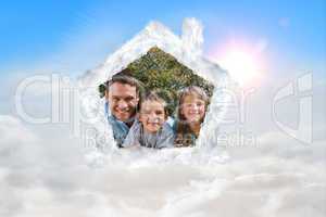 Composite image of happy family lying on the grass