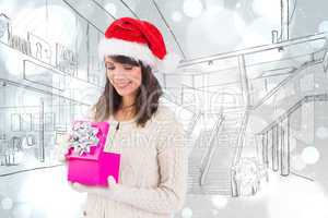 Composite image of smiling brunette opening christmas gift