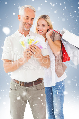 Happy couple with shopping bags and cash