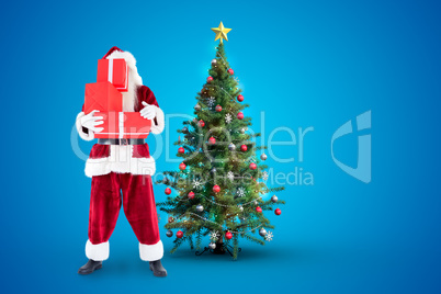 Composite image of santa covers his face with presents