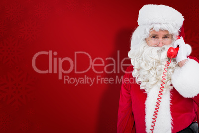 Composite image of smiling santa claus on the phone