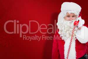 Composite image of smiling santa claus on the phone