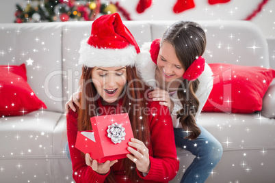 Composite image of festive mother and daughter with a christmas