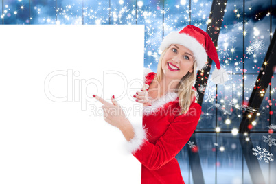 Composite image of festive blonde showing white card