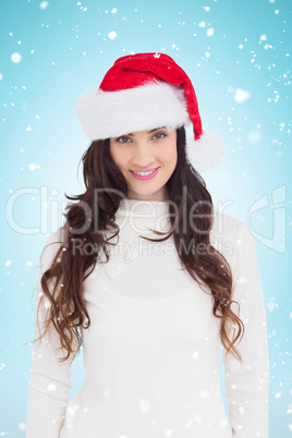 Composite image of beautiful brunette in santa hat smiling at ca