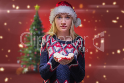 Composite image of festive blonde holding her hands out