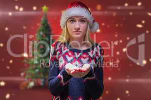 Composite image of festive blonde holding her hands out