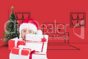 Composite image of festive blonde holding pile of gifts