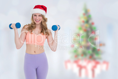 Composite image of festive fit blonde holding dumbbells Composite image of festive fit blonde holding dumbbells