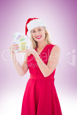 Festive blonde in red dress showing her cash