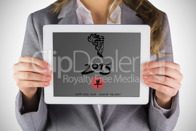 Composite image of businesswoman showing a tablet pc