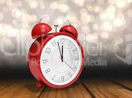 Composite image of alarm clock counting down to twelve