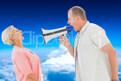 Composite image of man shouting at his partner through megaphone