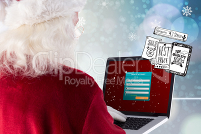 Composite image of santa claus uses a laptop