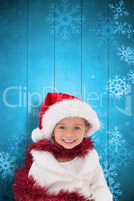 Composite image of cute little girl wearing santa hat and tinsel