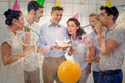 Composite image of casual businessmen team celebrating a birthda